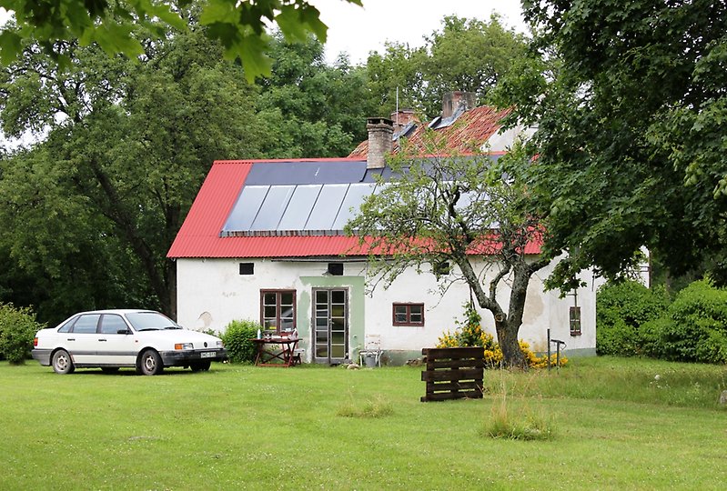Ett vitt hus med solpaneler på taket.
